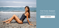 Black one piece swimsuit with crisscross detail and scoop back, model on beach in san diego black swimsuit