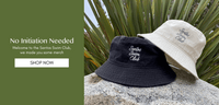 Santos Swim Club unstructured black and ivory bucket hats with script embroidery reading Santos Swim Club
